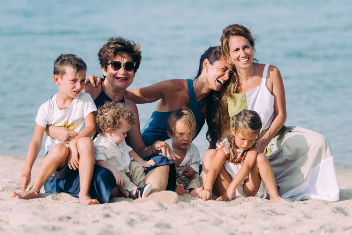 Family portrait on a rocky beach in white, Koh Samui family photographer